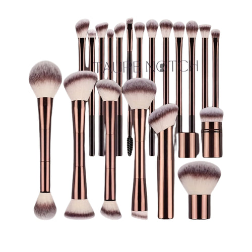 Makeup brush set with rose gold aluminum handles and soft purple bristles in assorted shapes.