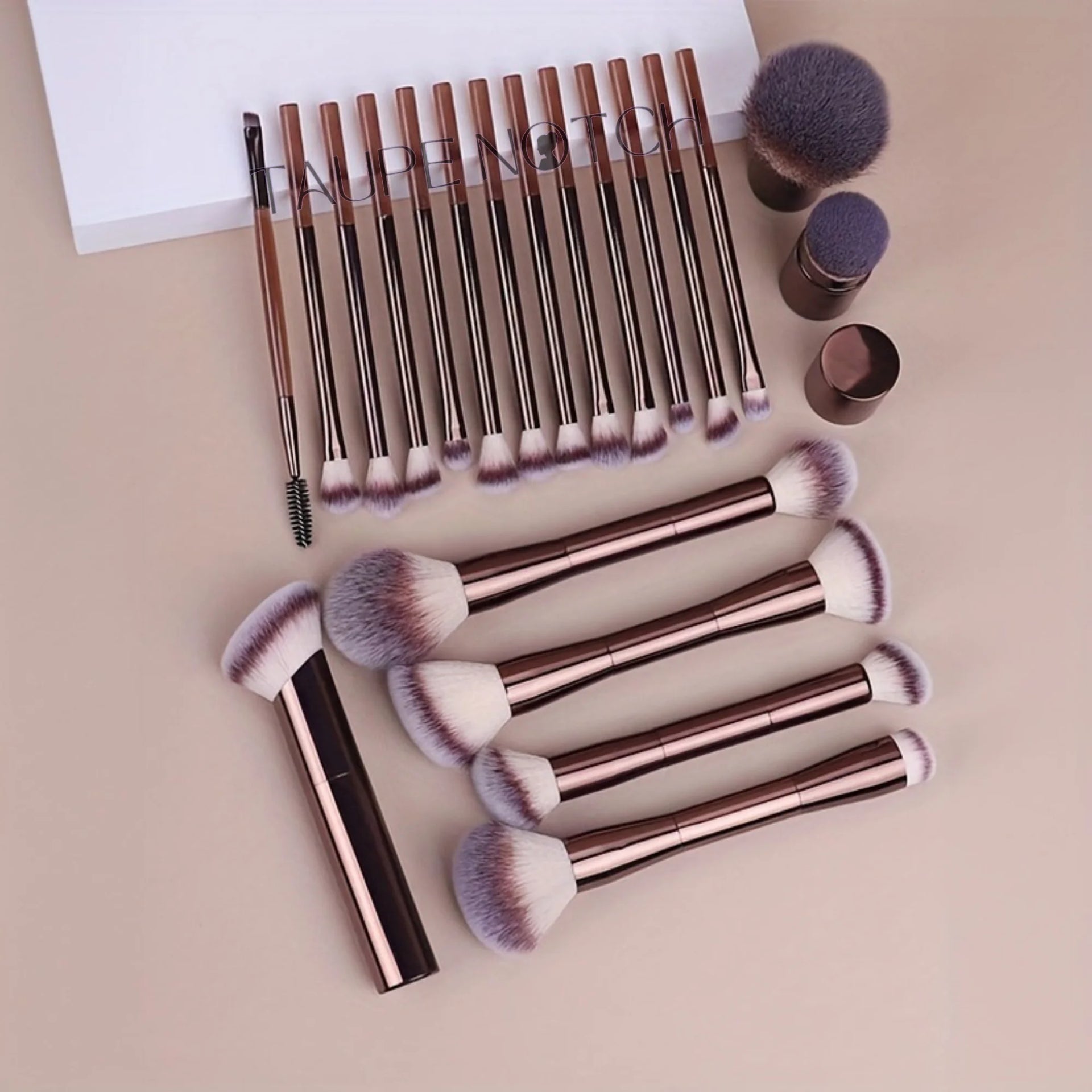 Makeup brush set with rose gold aluminum handles and soft purple bristles, assorted brush styles.
