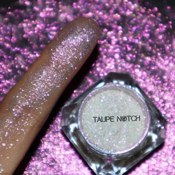 Taupe glitter nail polish bottle with textured cap and starry sparkle finish