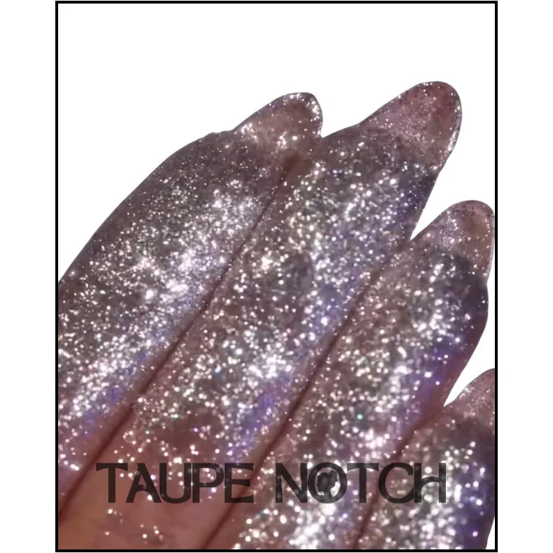 Taupe glitter fabric with scattered star sparkles, close-up texture
