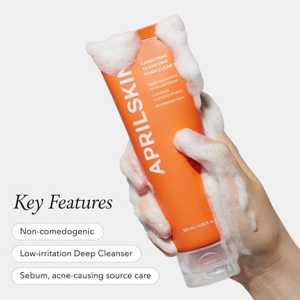 APRILSKIN clarifying foam cleanser with foamy lather on hand and orange tube