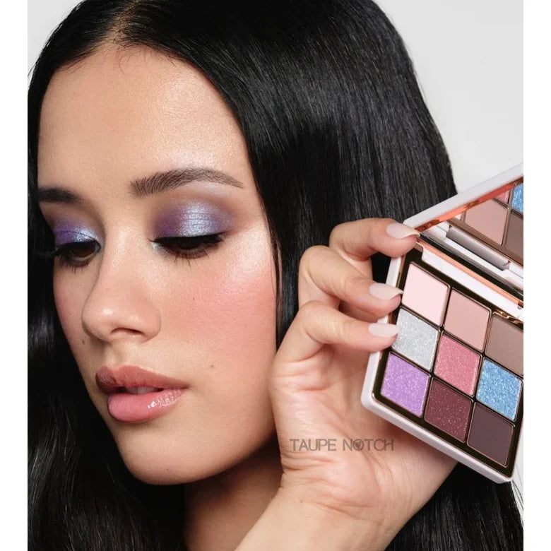 Mini eyeshadow palette held beside face, showing 9 shimmer and matte shades