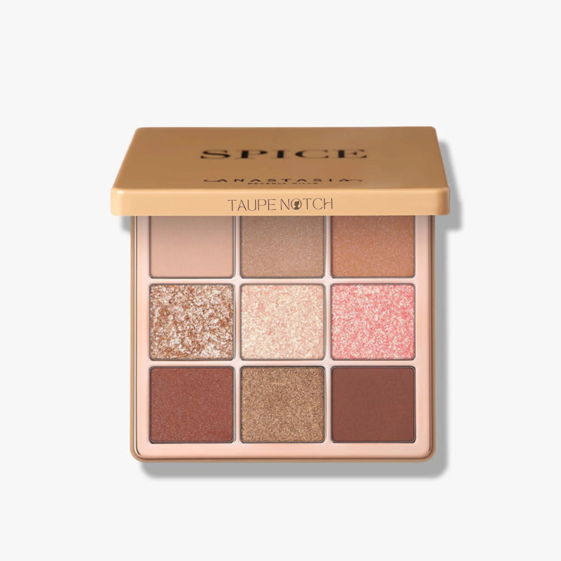 Mini eyeshadow palette open, matte browns and glittery taupe, rose, copper shades.
