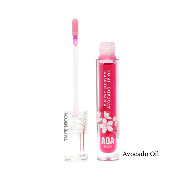 Lip oil tube with cherry blossom print, labeled Avocado Oil, pink applicator wand