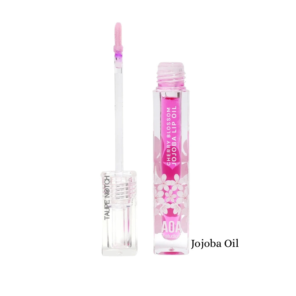 Lip oil tube with cherry blossom print, labeled Jojoba Oil, pink applicator tip