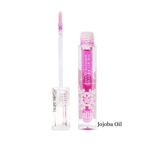 Lip oil tube with cherry blossom print, labeled Jojoba Oil, pink applicator tip