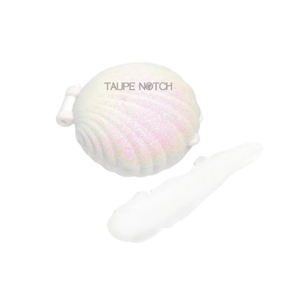 AOA Seashell Sheer Lip Balm by Taupe Notch with coconut scent, showing the clear lip balm in a small container.