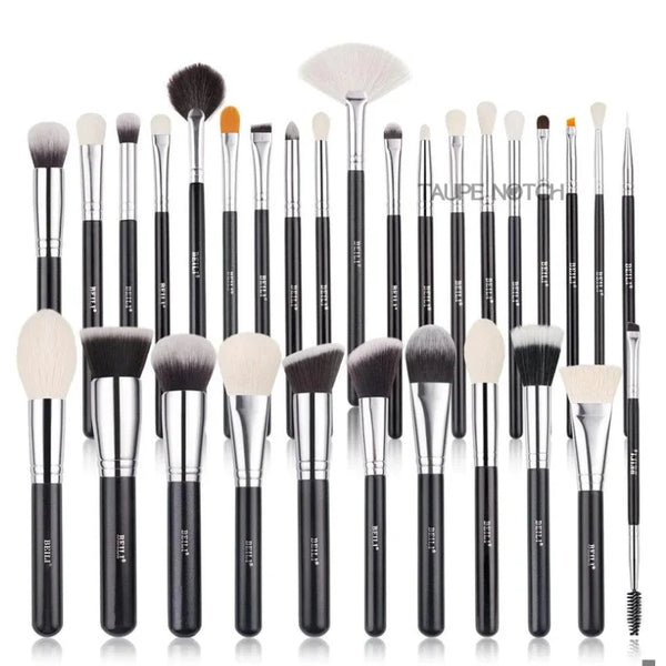 Makeup brush set with multiple brush heads, black handles, and silver ferrules