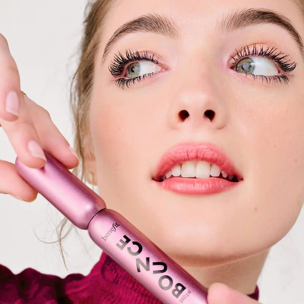 Volumizing mascara brush applying dark lashes; Pump'd Up Black on model