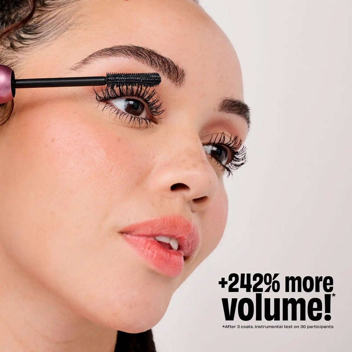 A girl using Benefit BADGal Bounce Volumizing Mascara Where she’s showing the volume of the mascara