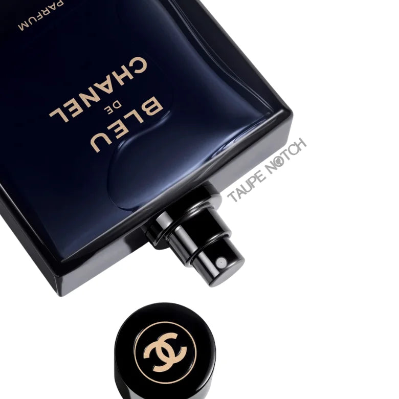 Parfum spray bottle with silver atomizer and black cap with gold CHANEL logo