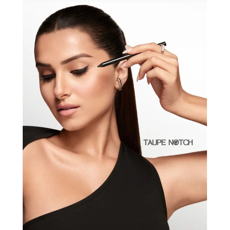 Woman applying waterproof kajal eyeliner pencil along upper lash line.