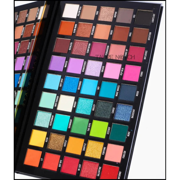 Eyeshadow palette with colorful square shade pans in a grid, angled close-up