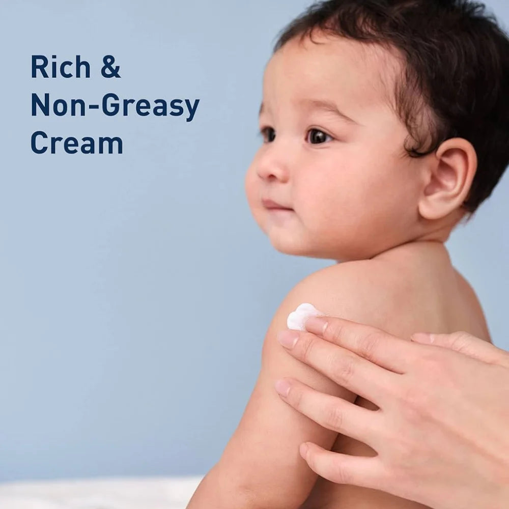 Baby skin care cream applied with hand, dollop on shoulder