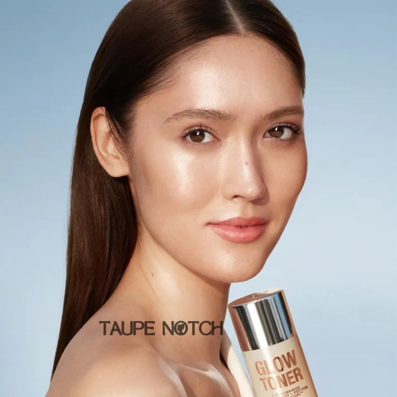 Glow toner bottle with silver cap next to woman’s face, Taupe Notch label
