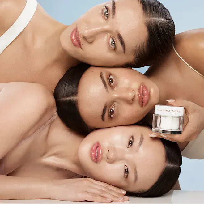 Skincare model holding Charlotte Tilbury Magic Water Cream jar near face