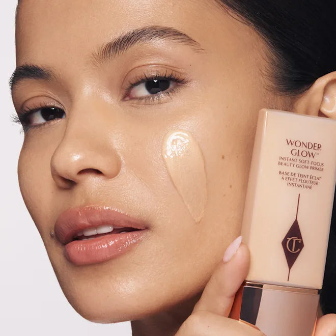 Charlotte Tilbury WonderGlow face primer tube beside glowing skin