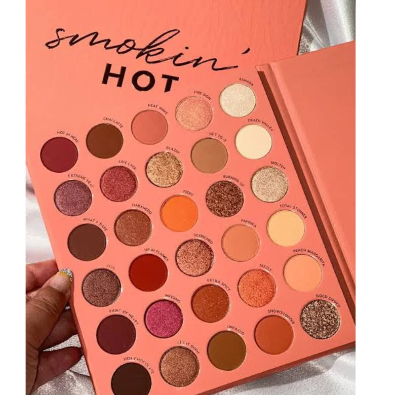 Compact eyeshadow palette with peach cover and warm neutral shades.
