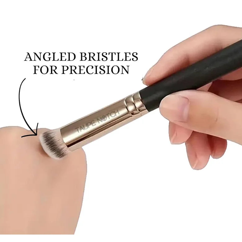 Concealer blending brush angled bristles with black handle held in hand