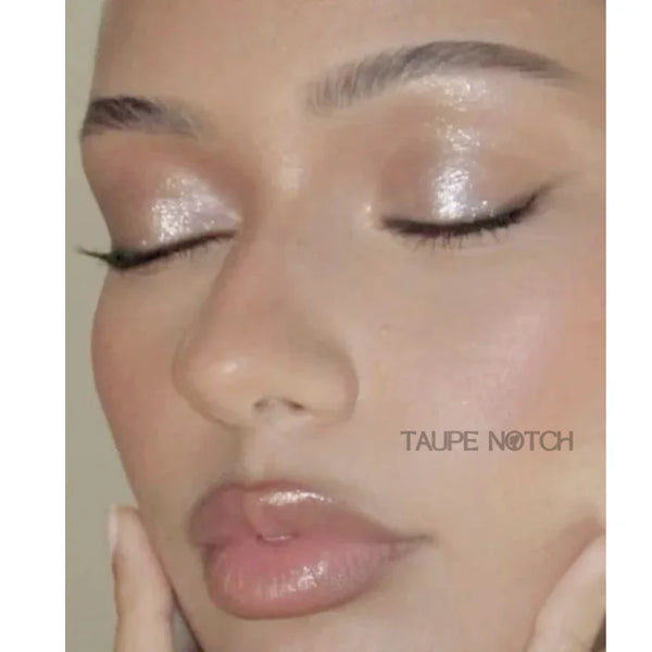 Taupe shimmer eyeshadow on closed eyelids with glossy lips