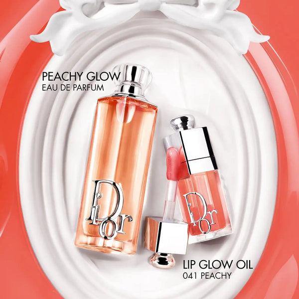 Dior Addict Peachy Glow eau de parfum bottle with peach-orange glass and clear cap