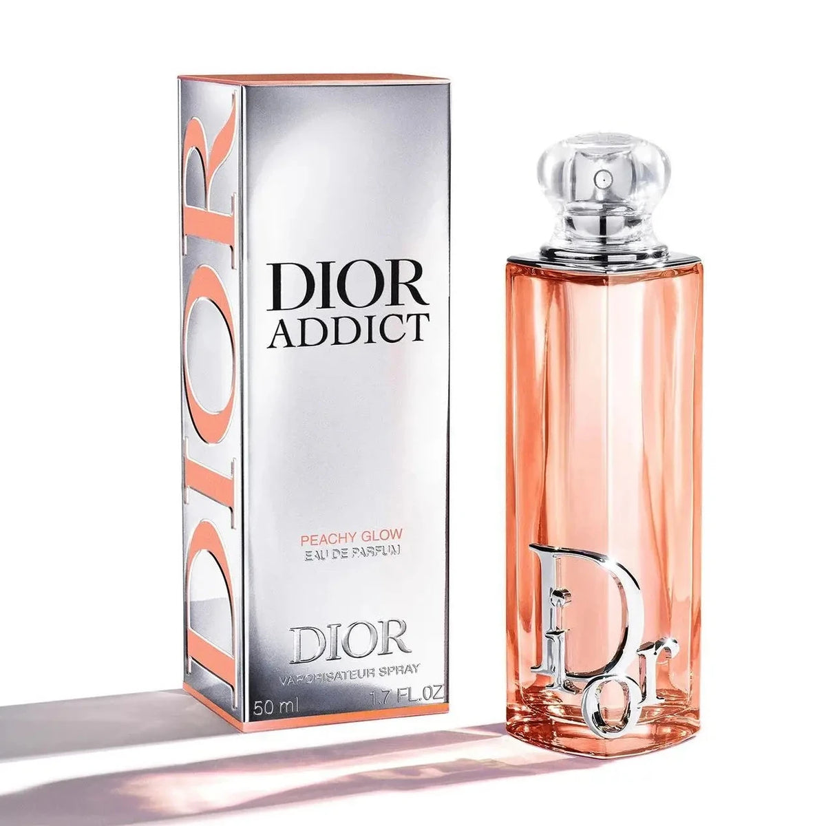 Dior Addict Peachy Glow eau de parfum box and bottle, peach-orange glass with clear cap