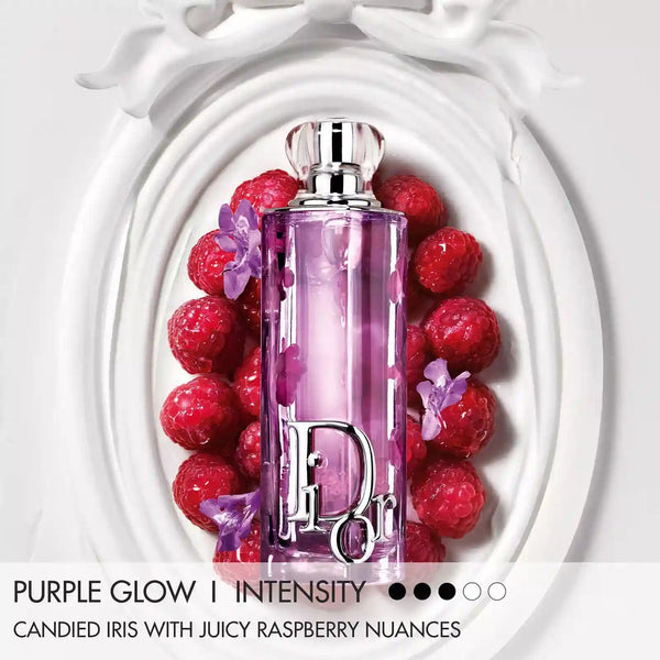 Purple Glow eau de parfum bottle in lilac glass surrounded by red berries