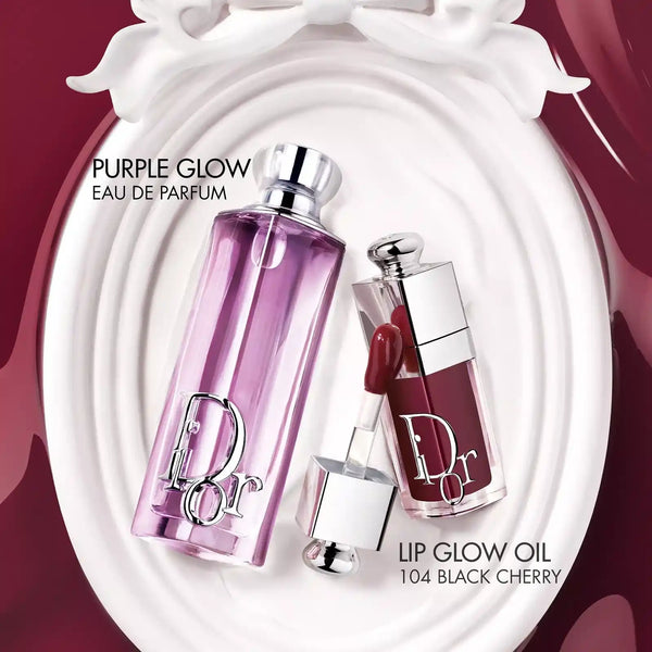 Purple Glow eau de parfum bottle with lilac glass and silver cap, plus lip oil