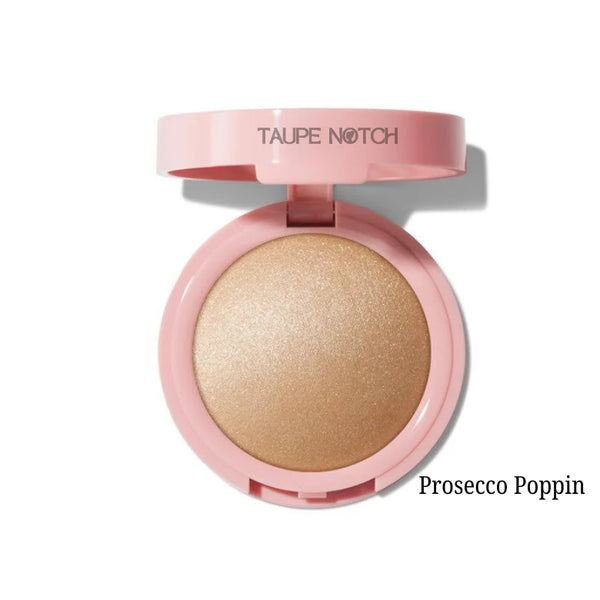 Silky powder highlighter compact with champagne-gold pan, pink casing; Prosecco Poppin shade.
