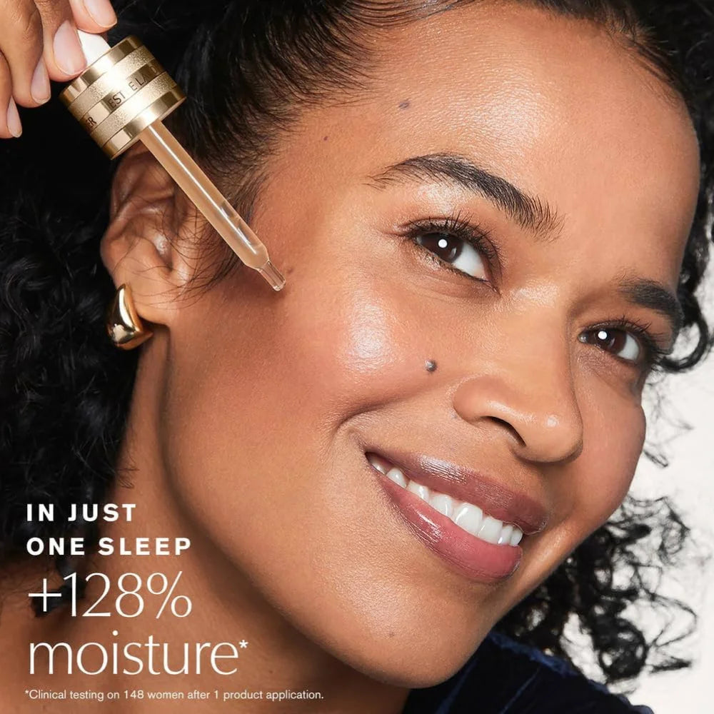 Face serum application: woman using gold dropper above cheek