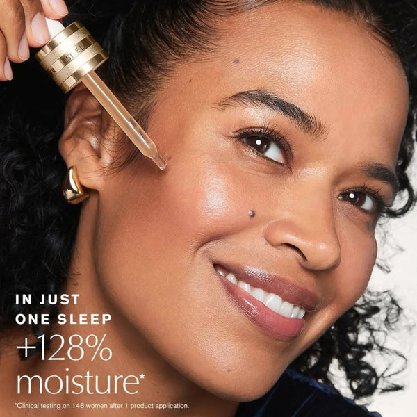 Face serum application: woman using gold dropper above cheek