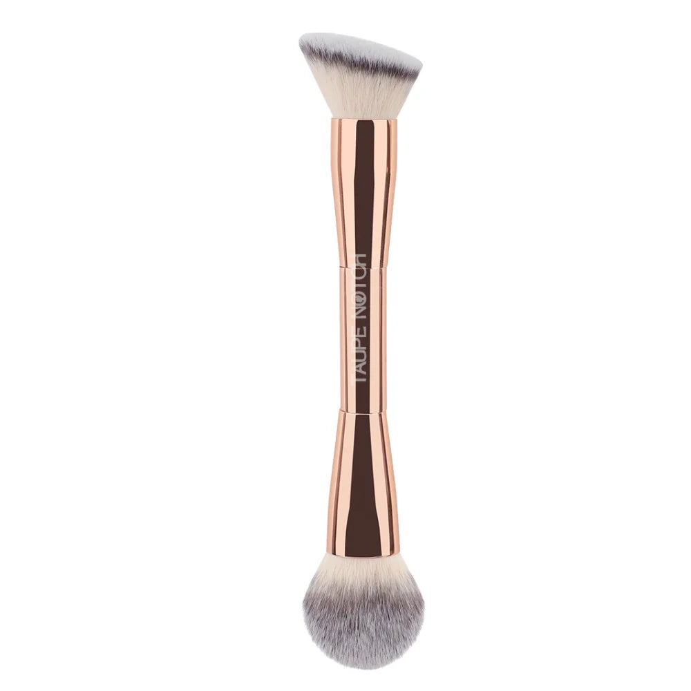 Face brush with rose-gold handle and dense gray-white domed bristles