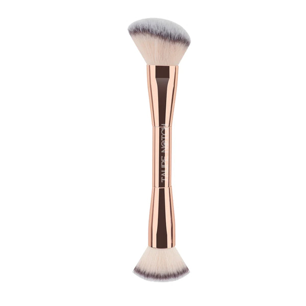 Face brush with rose-gold handle and gray-white tapered bristles