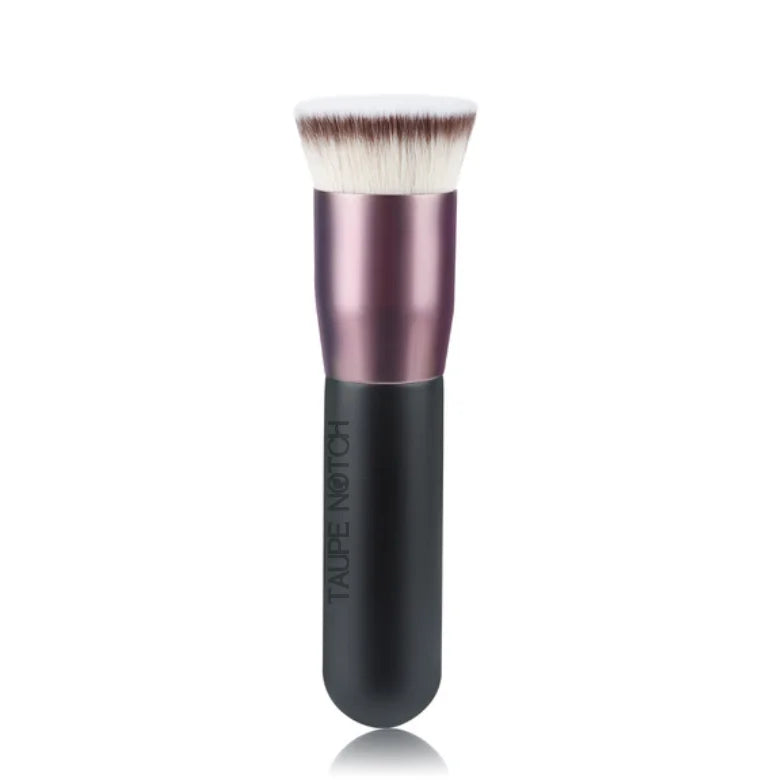 Foundation buffing brush with rose-pink ferrule, black base, and fluffy white bristles