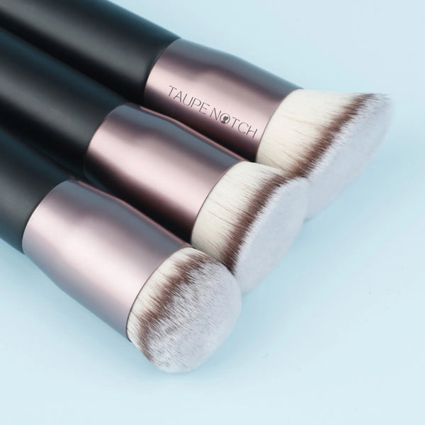 Foundation buffing brush with TAUPENOTCH rose-gold ferrule and white bristles