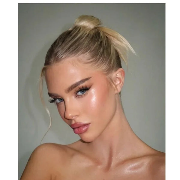 Shimmery champagne highlighter glow on cheek and shoulder