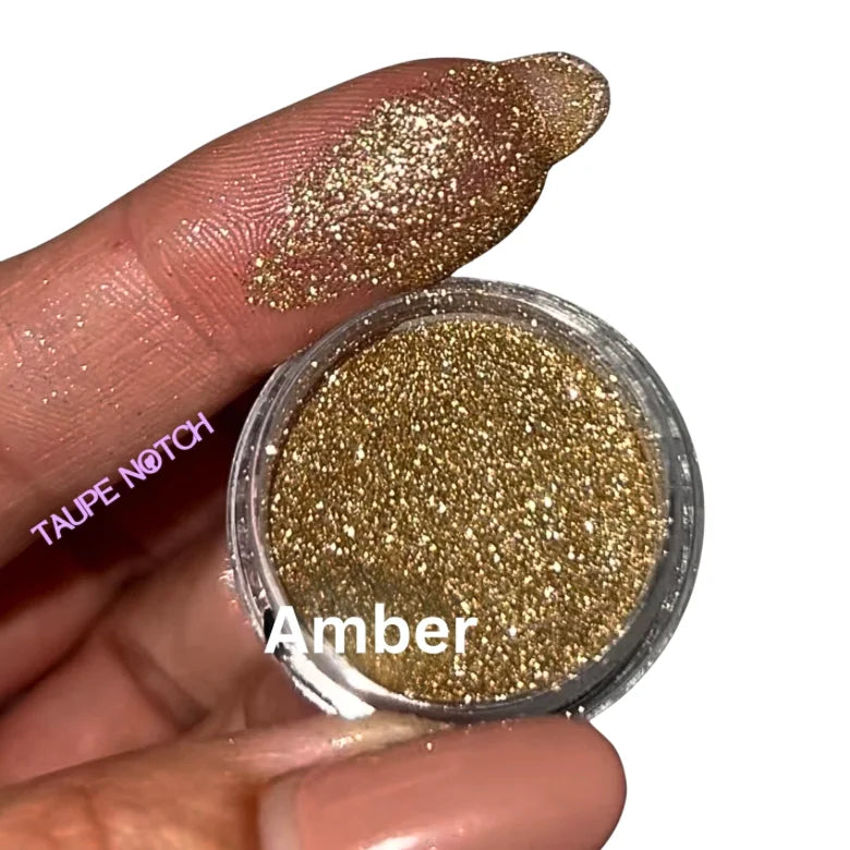 Amber glitter in small clear jar with gold sparkling powder
