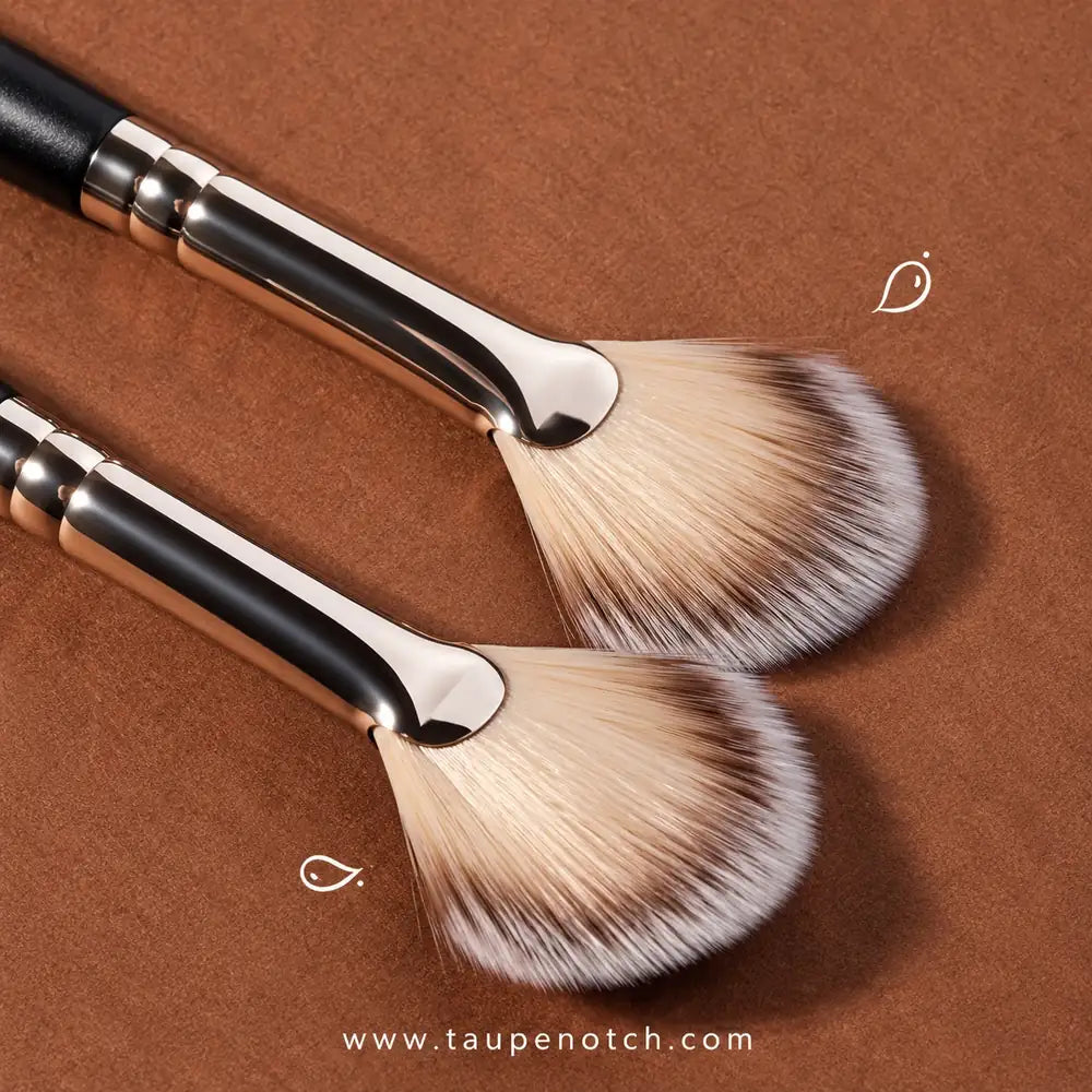 Fan-shaped blush and highlighter brushes with black handles and soft beige bristles