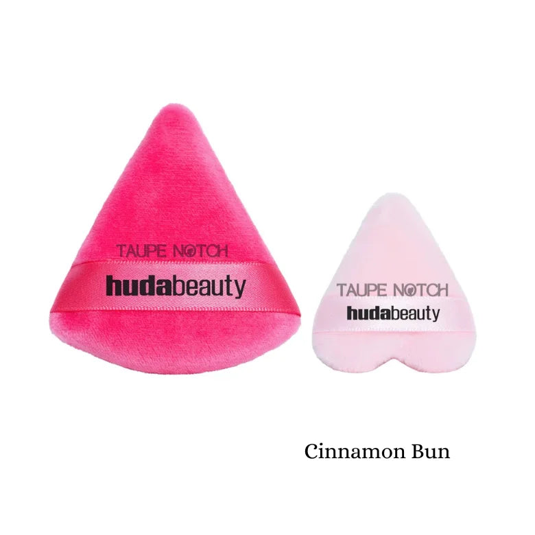 Huda Beauty Cinnamon Bun triangle powder puffs in hot pink and light pink velvet showing both sizes on white background