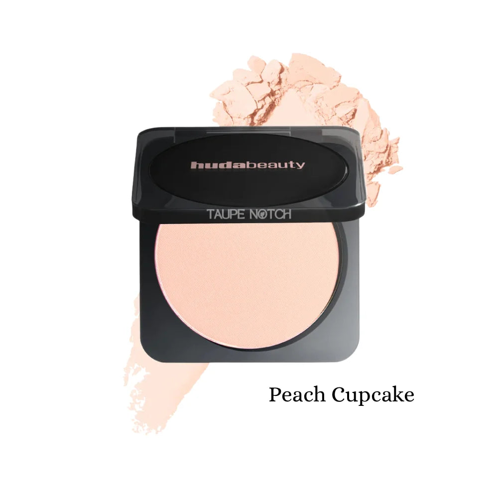 Pressed powder compact with light peach shade; black lid, oval pan, peach swatch