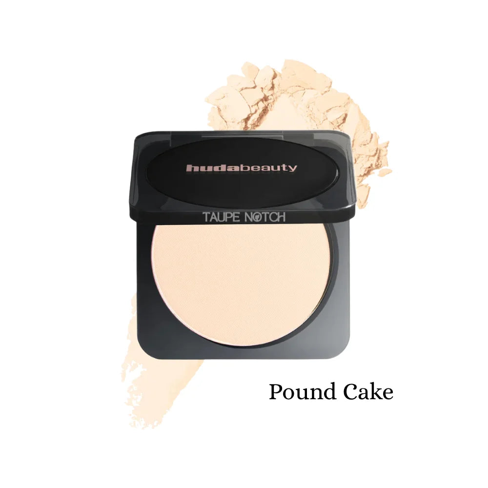 Pressed powder compact with neutral beige shade; black lid, oval pan, cream swatch