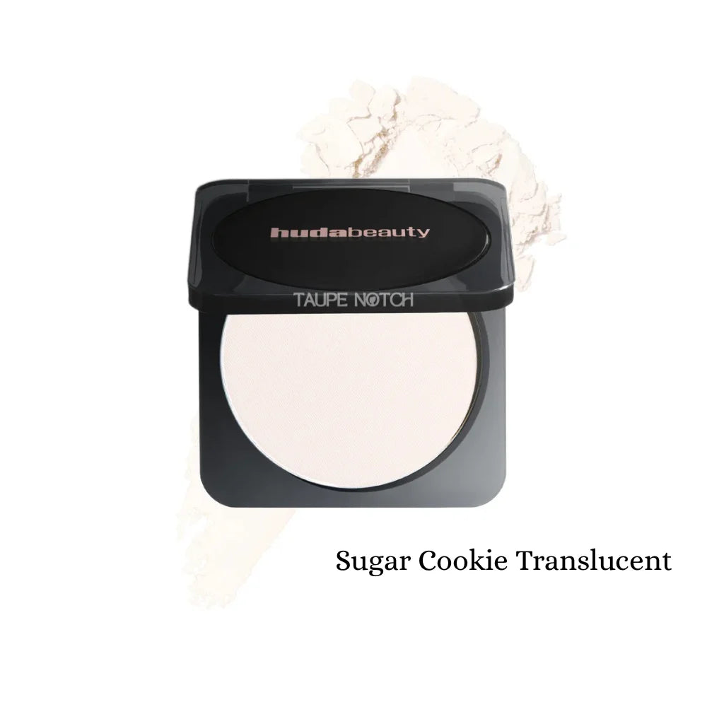 Pressed powder compact with light translucent beige shade; black lid, oval pan, pale swatch