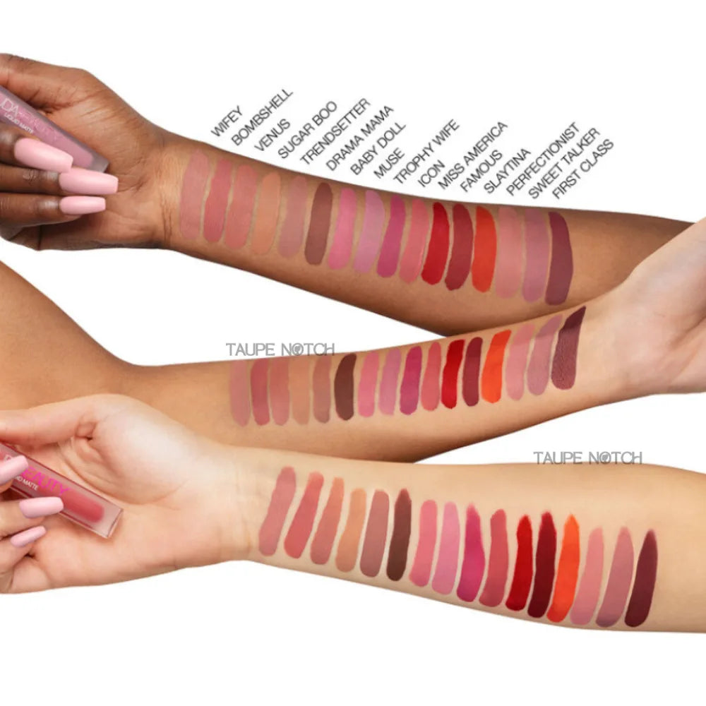 Huda Beauty liquid matte lipstick swatches on arm with applicator.