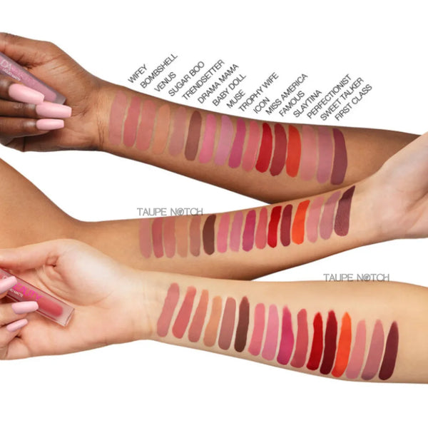 Huda Beauty liquid matte lipstick swatches on arm with applicator.
