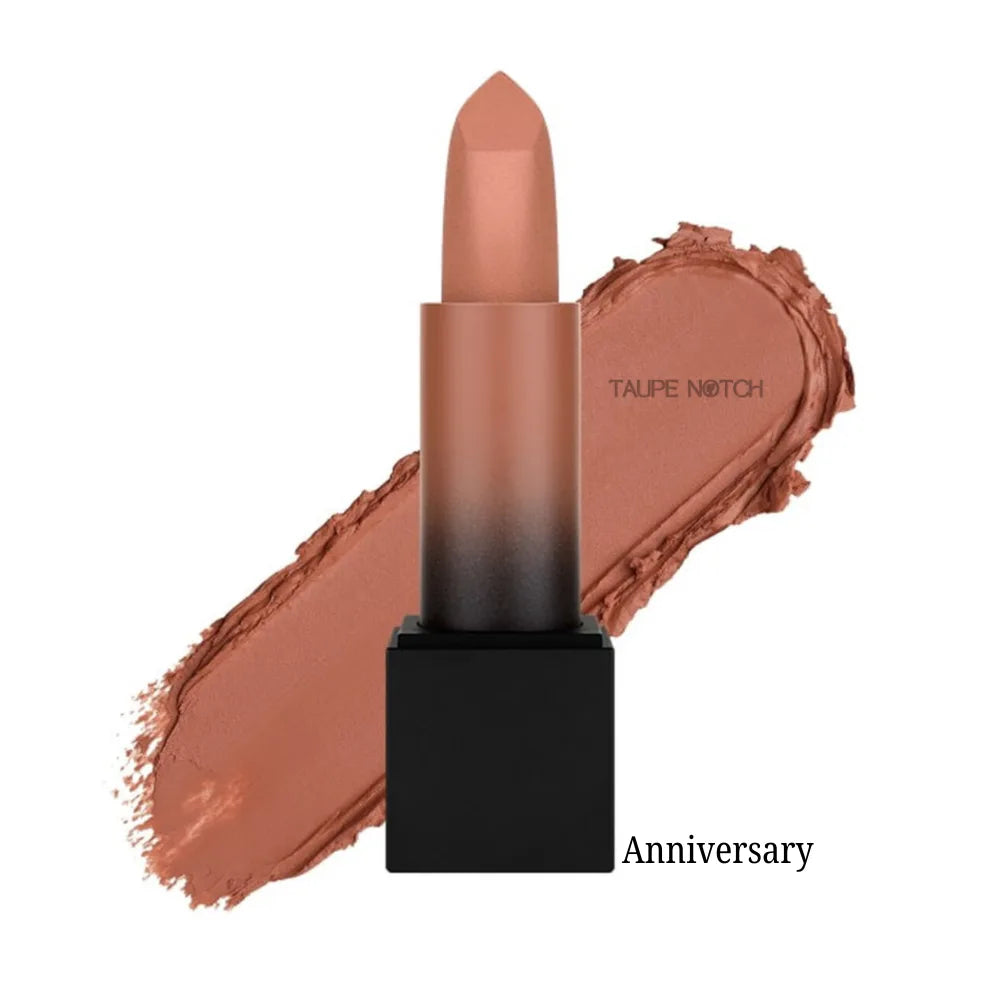 Matte lipstick bullet with warm nude-brown shade on lip swatch, “Anniversary” label