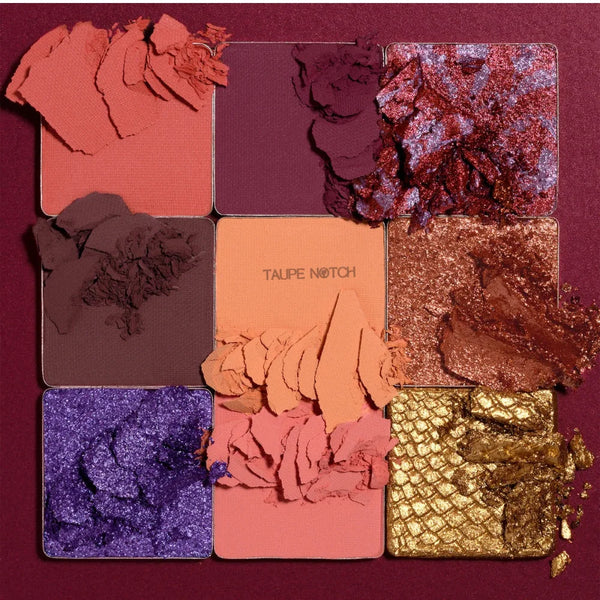 Eyeshadow palette close-up with glittery pans in purple, taupe, pink, bronze, and gold