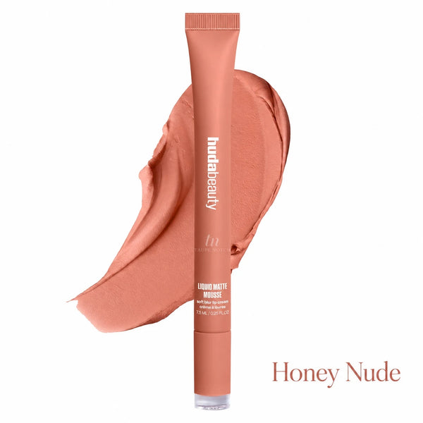 A tube of hud beauty liquid matte moisturizer in the shade Honey Nude, shown upright with a matching peachy nude cream smear behind it on a white background.