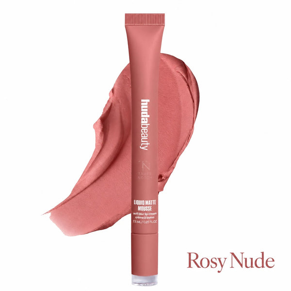 A tube of hudabeauty Liquid Matte Mousse lip product in the shade Rosy Nude, shown upright in front of a matching pinkish nude smear on a white background.