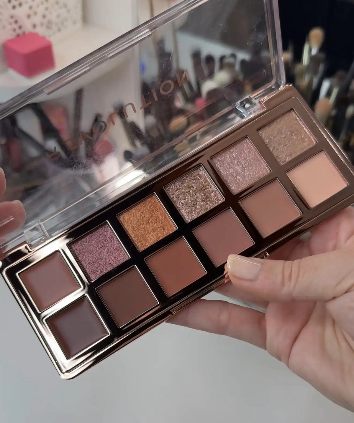 Bronze eyeshadow palette with 9 pan shades in warm brown and shimmer finishes