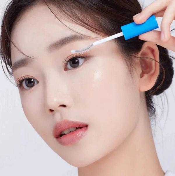 SEAPURI eyelash enhancing serum applicator held near model's eye lash line